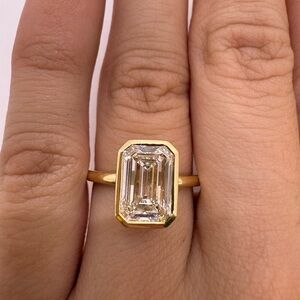 3.09 carat E VS1 emerald cut lab diamond bezel solitaire engagement ring yellow